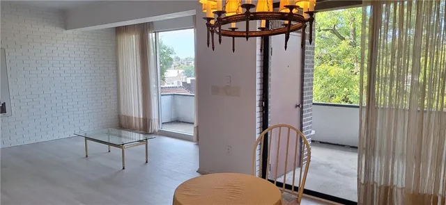 a view of a room with floor to ceiling window and wooden floor