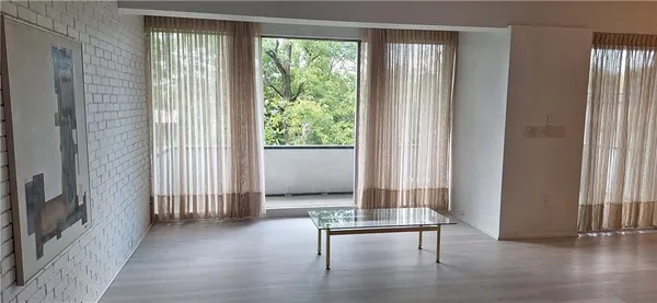 a view of a hallway with furniture and a window