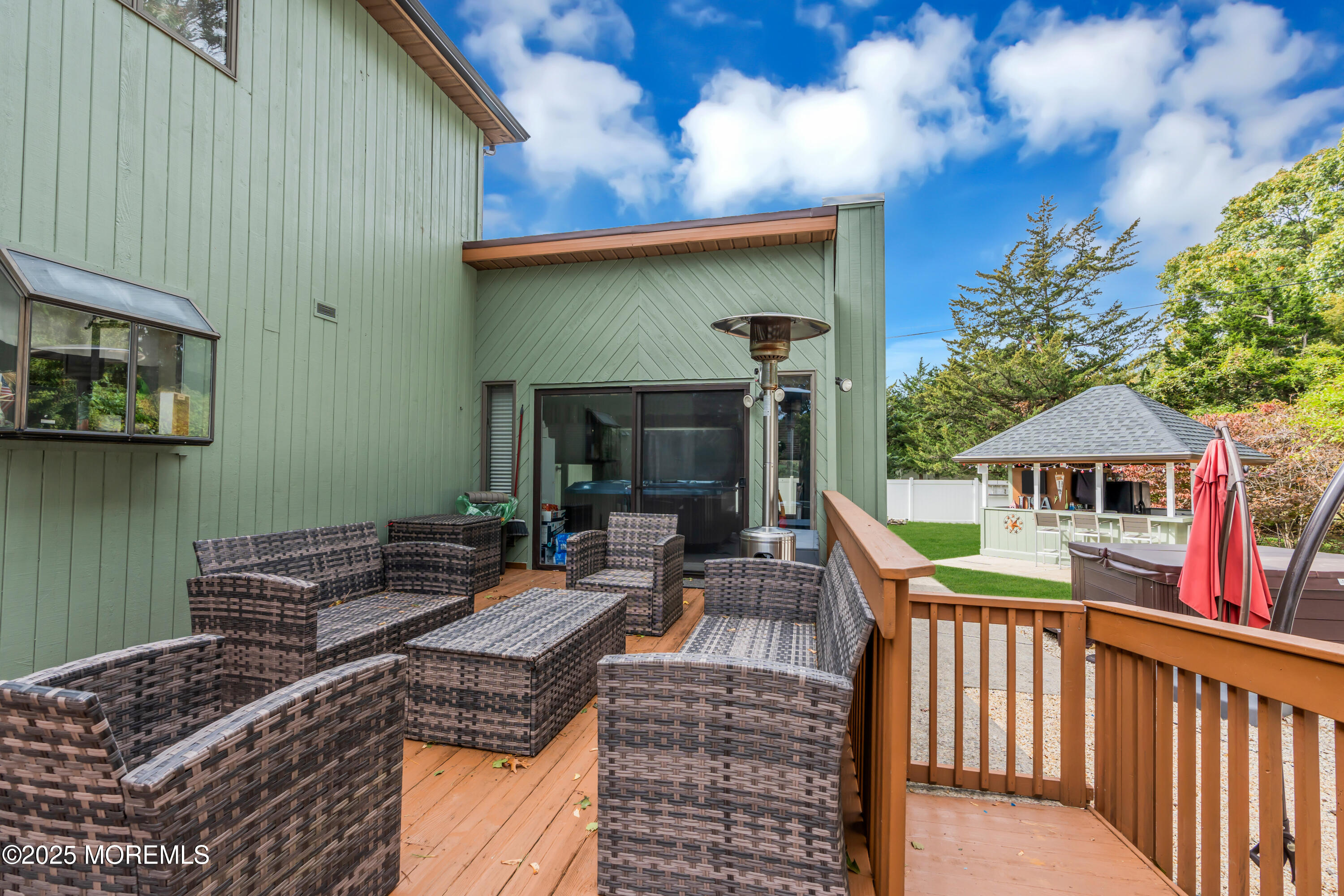 581 Winding River Road Brick, NJ 08724 - Photo 52 of 91 a view of a patio with couches table and chairs under an umbrella