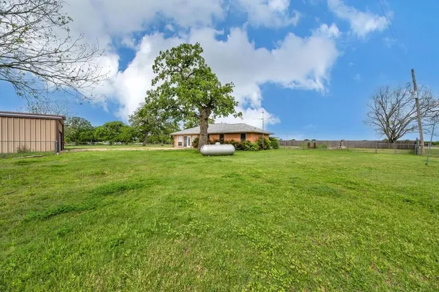 a view of a house with a big yard