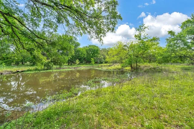 a view of a lake with a yard