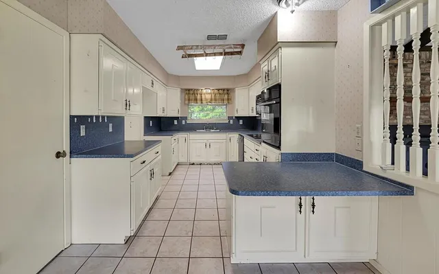 a kitchen with stainless steel appliances granite countertop a sink refrigerator and cabinets