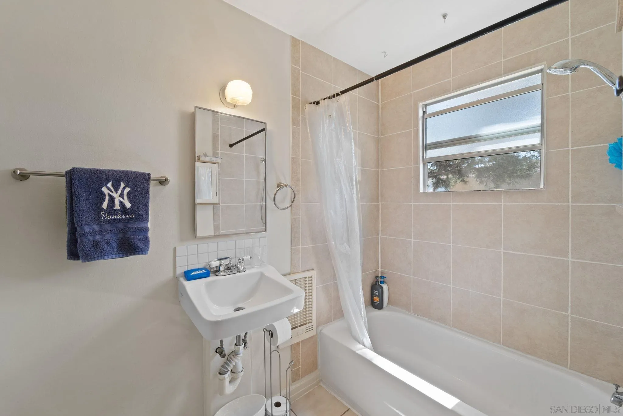 345 Cedar Street El Cajon, CA 92021 - Photo 11 of 19 a bathroom with a sink a mirror a bathtub and shower