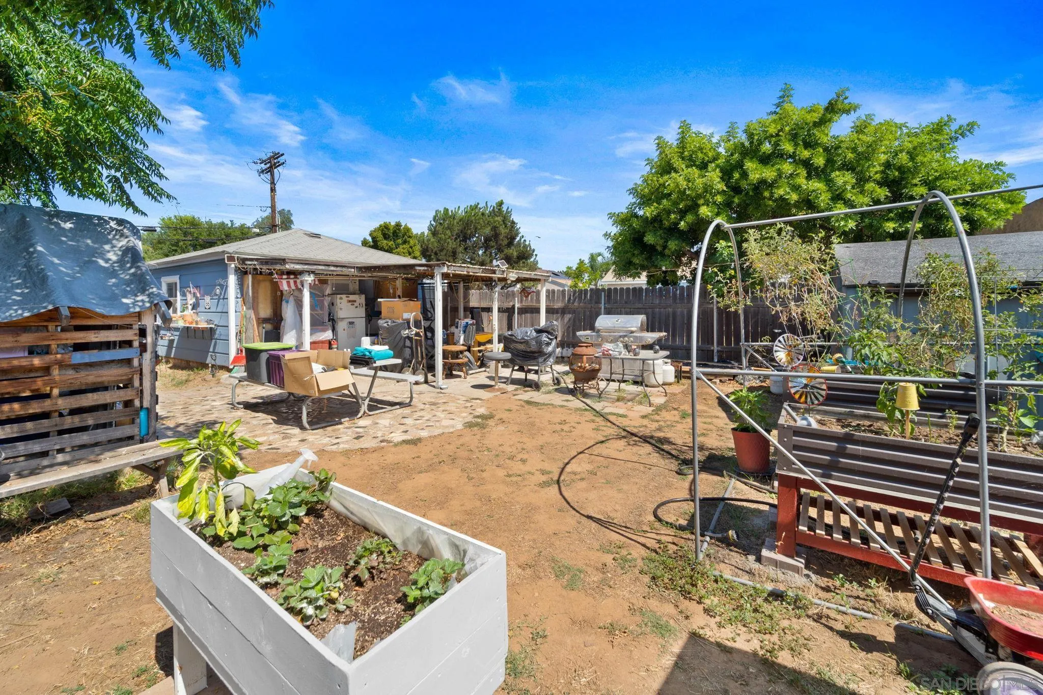 345 Cedar Street El Cajon, CA 92021 - Photo 15 of 19 a view of a patio with couches table and chairs with potted plants and large tree