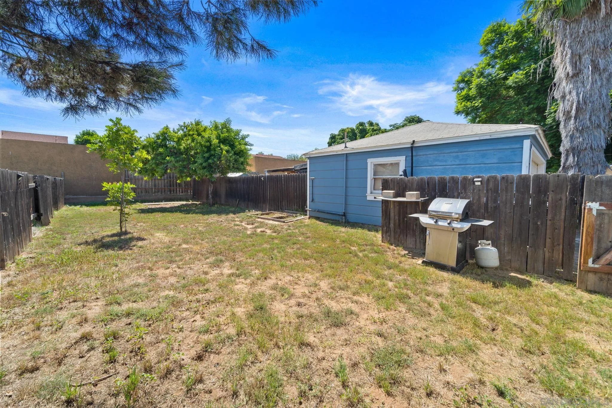 345 Cedar Street El Cajon, CA 92021 - Photo 18 of 19 a view of a backyard with table and chairs and potted plants