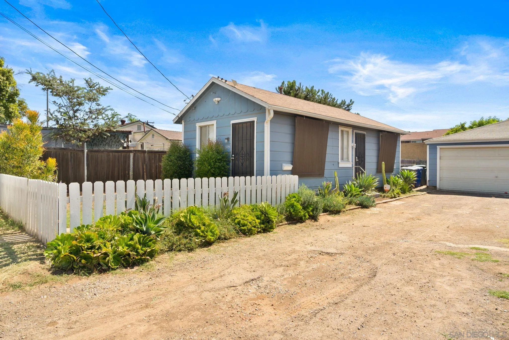 345 Cedar Street El Cajon, CA 92021 - Photo 2 of 19 a front view of a house with garden