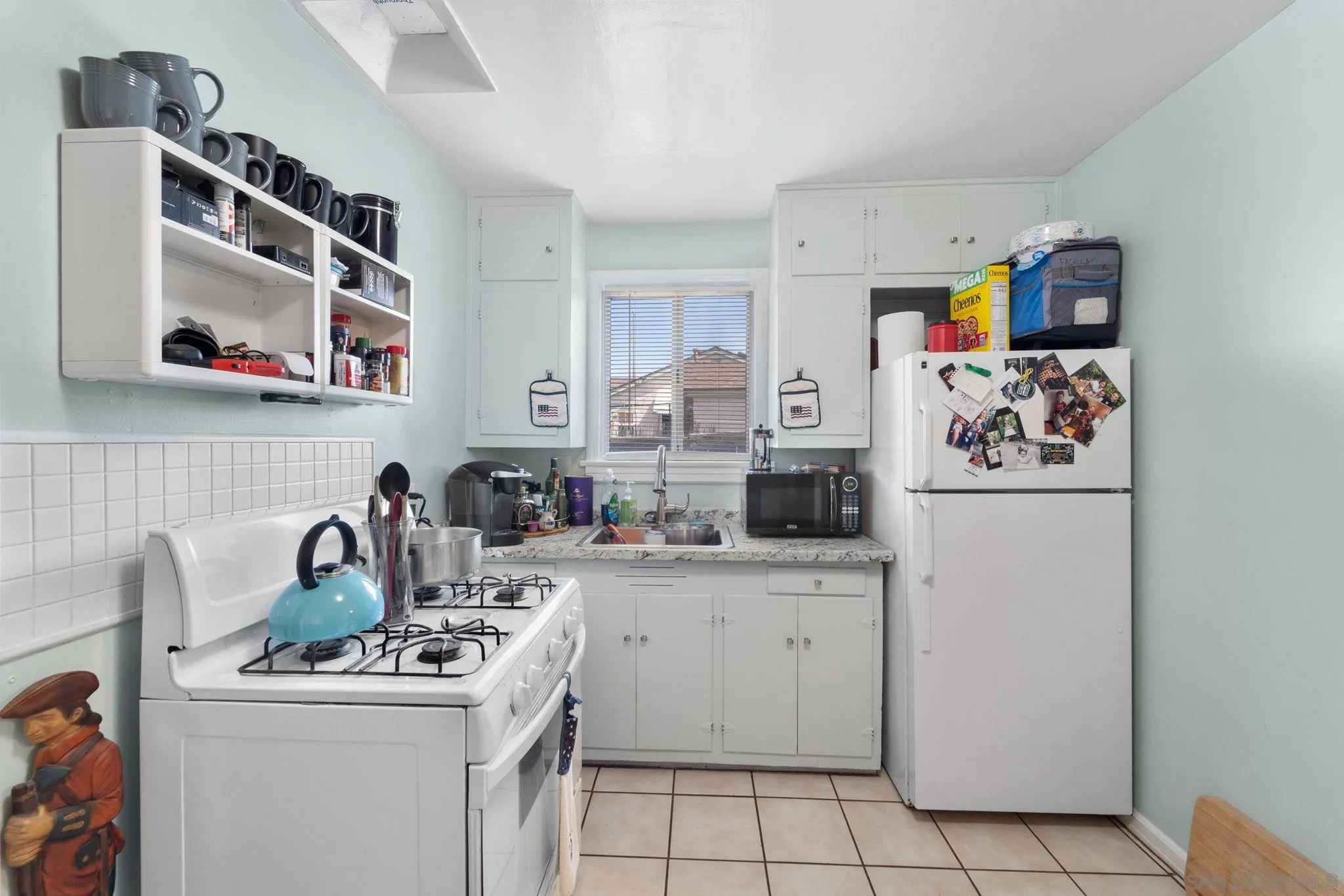 345 Cedar Street El Cajon, CA 92021 - Photo 5 of 19 a kitchen with a sink a stove and cabinets