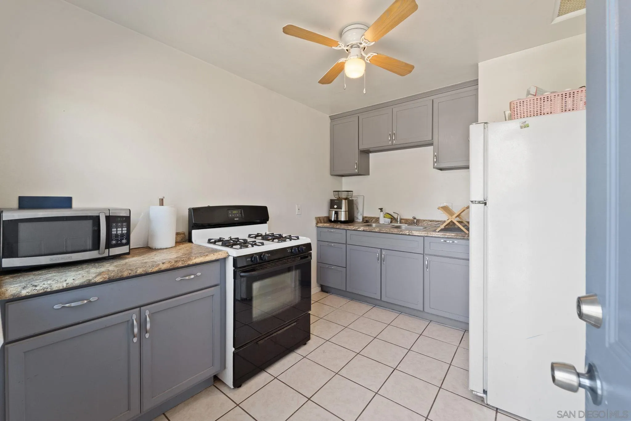 345 Cedar Street El Cajon, CA 92021 - Photo 9 of 19 a kitchen with stainless steel appliances granite countertop a stove a sink and a refrigerator