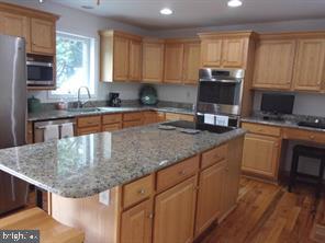 28880 Hudson Road Dagsboro, DE 19939 - Photo 11 of 29 a kitchen with stainless steel appliances granite countertop a sink stove and microwave