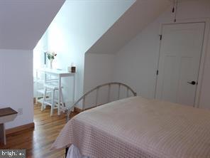 28880 Hudson Road Dagsboro, DE 19939 - Photo 17 of 29 a bedroom with a bed a table and chair