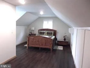 a view of a small space with wooden floor and a window