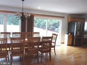 a kitchen with kitchen island stainless steel appliances a sink stove refrigerator and cabinets