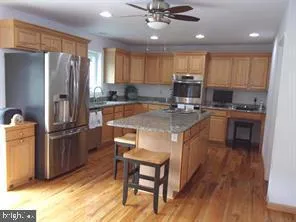 a kitchen with stainless steel appliances granite countertop a sink stove and microwave