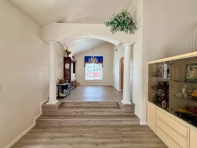 a view of entryway and hall with wooden floor
