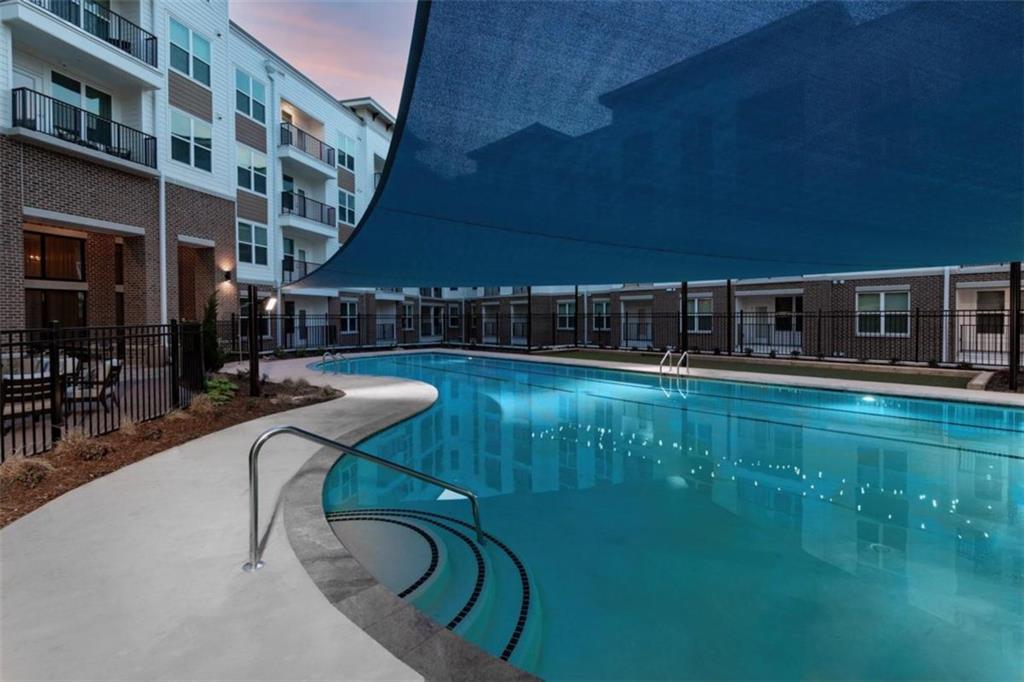 1927 Powers Ferry Road, Unit 522 Atlanta, GA 30339 - Photo 19 of 33 a swimming pool with outdoor seating and yard