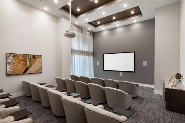 a media room with lots of chairs and a projector screen