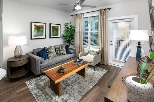 a living room with furniture and a potted plant