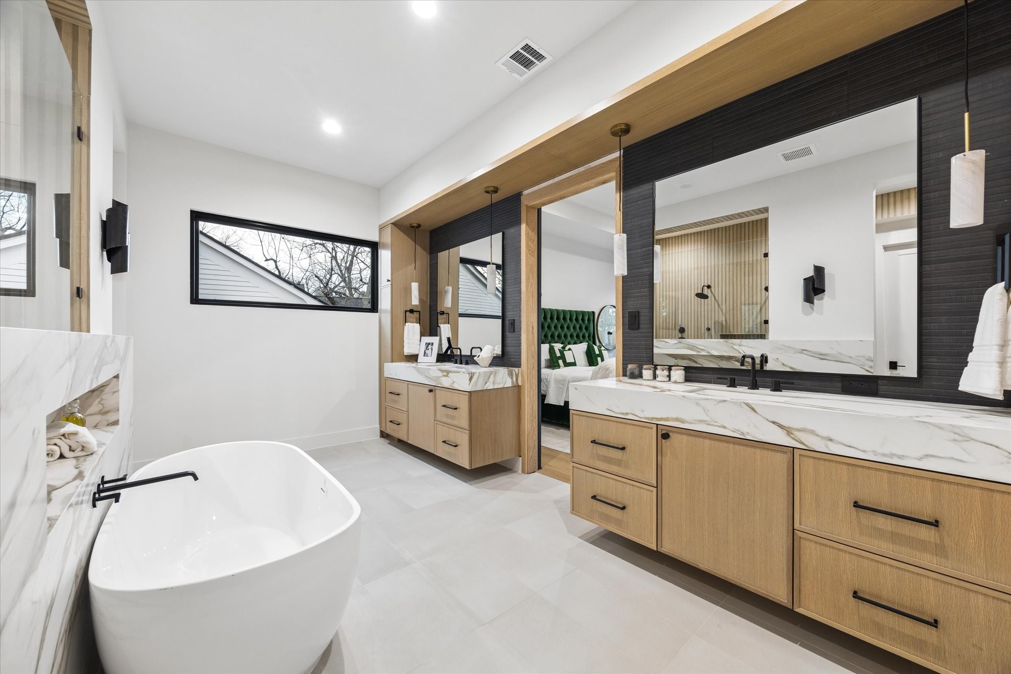 2102 Tangley Street Houston, TX 77005 - Photo 30 of 49 a spacious bathroom with a double vanity sink a mirror and a bathtub
