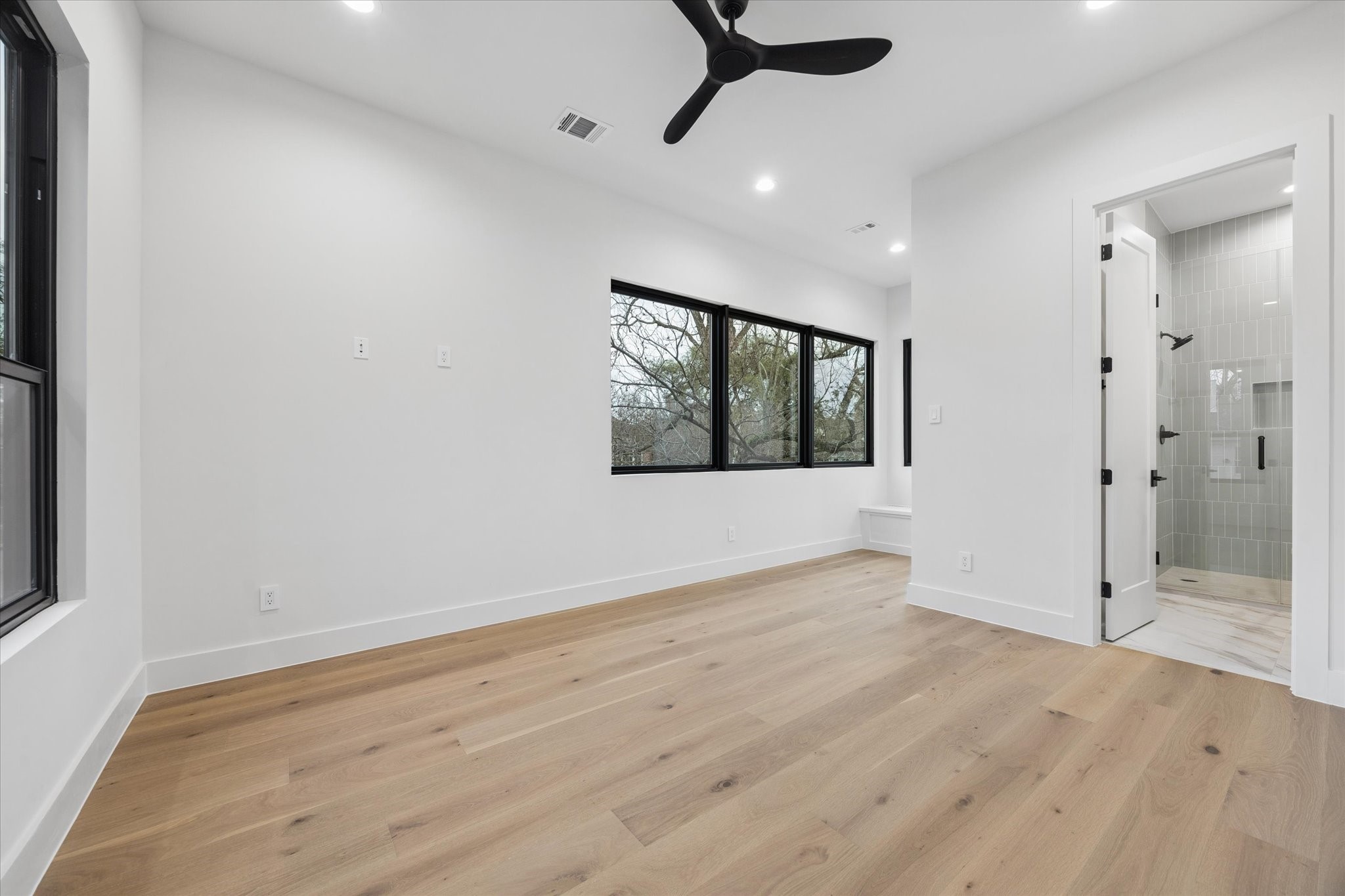 2102 Tangley Street Houston, TX 77005 - Photo 35 of 49 a view of an empty room with wooden floor and a window