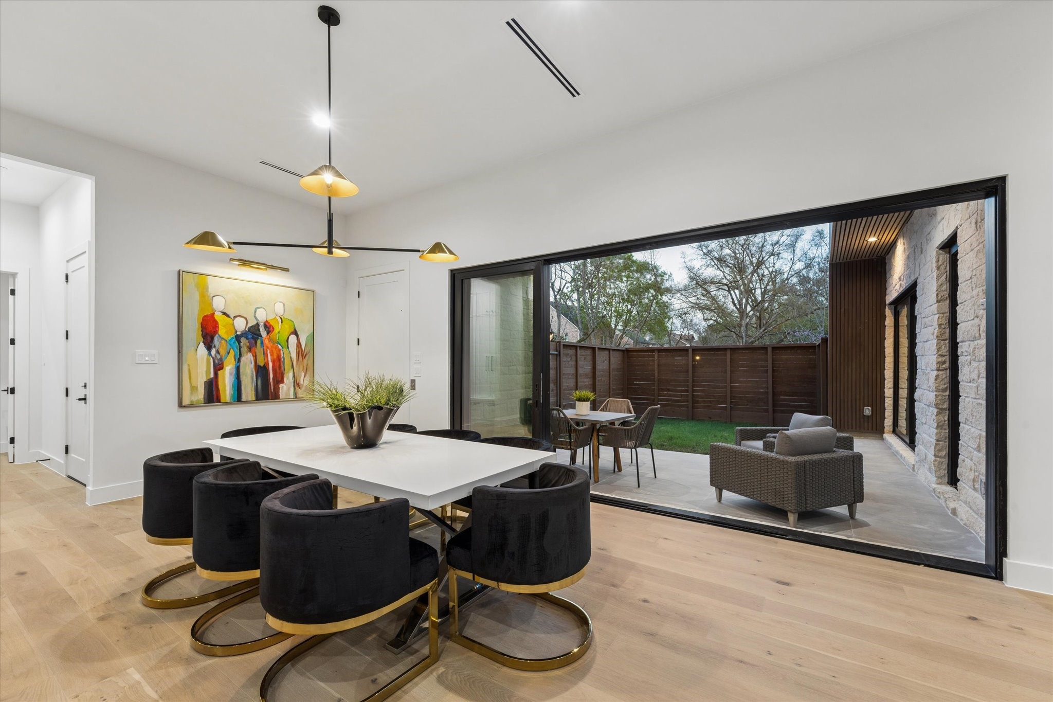 2102 Tangley Street Houston, TX 77005 - Photo 10 of 49 a dining room with furniture wooden floor and a chandelier