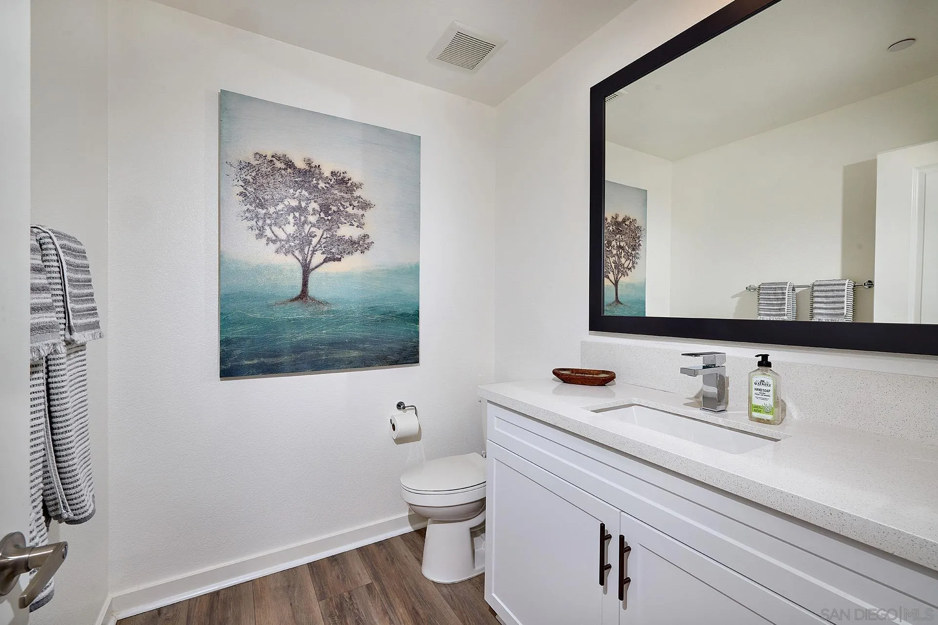 13070 Olympus Circle, Unit 1 Poway, CA 92064 - Photo 16 of 28 a bathroom with a toilet sink and mirror