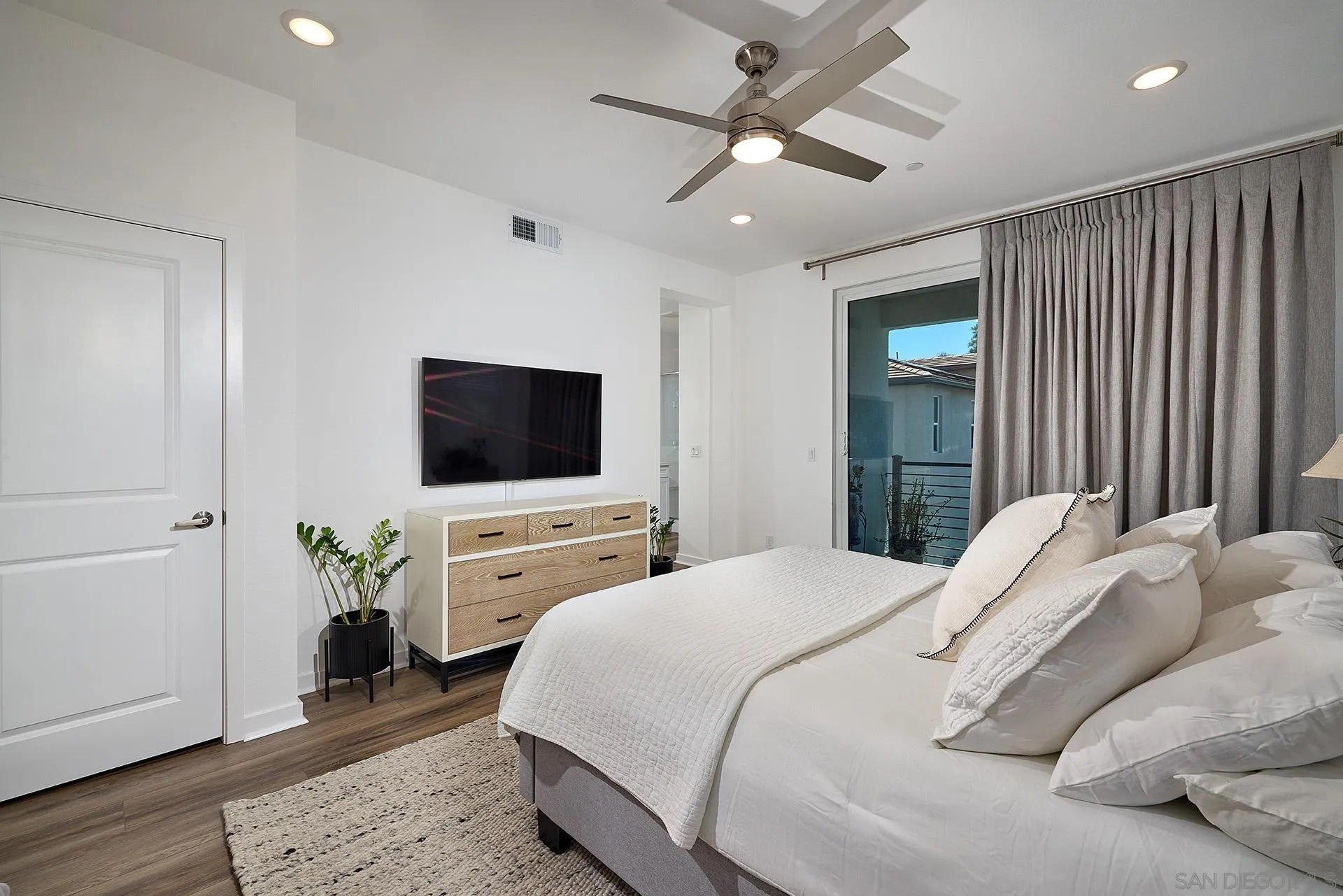 13070 Olympus Circle, Unit 1 Poway, CA 92064 - Photo 20 of 28 a bedroom with a bed and a flat screen tv