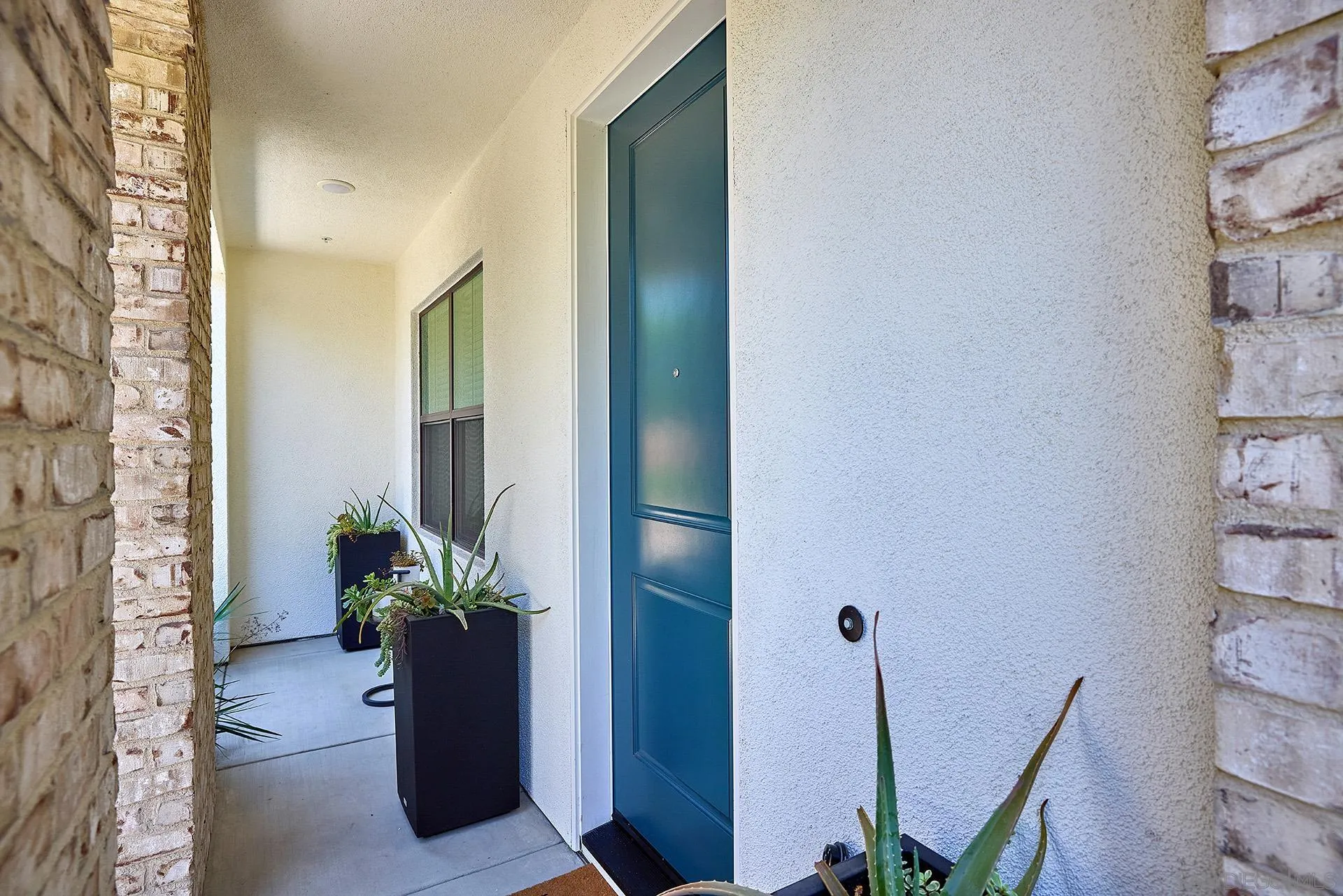 13070 Olympus Circle, Unit 1 Poway, CA 92064 - Photo 4 of 28 a view of a hallway with paintings on the wall