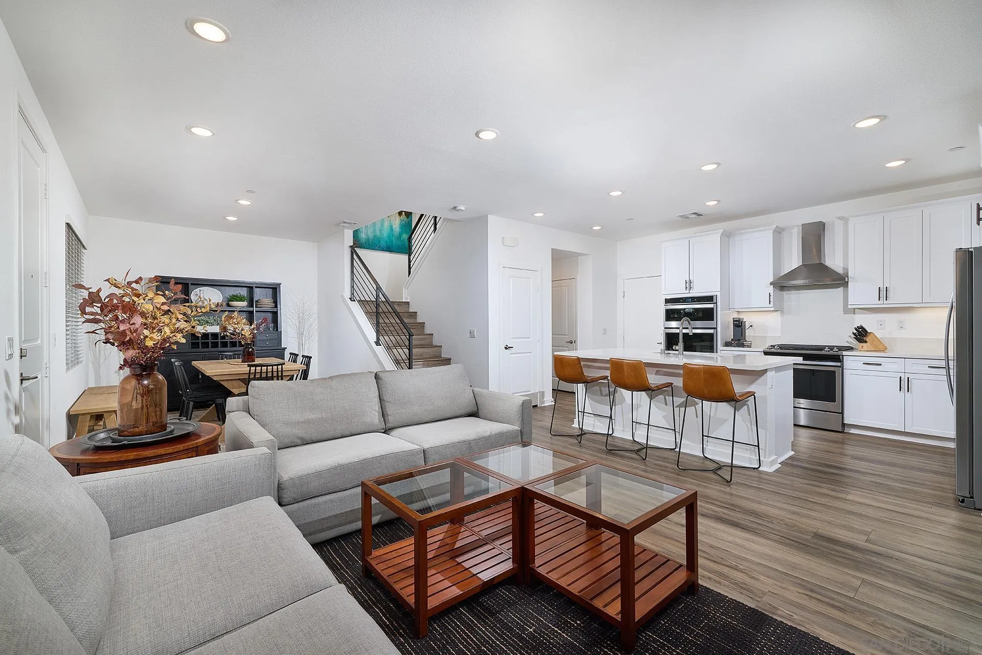 13070 Olympus Circle, Unit 1 Poway, CA 92064 - Photo 10 of 28 a living room with furniture and kitchen view