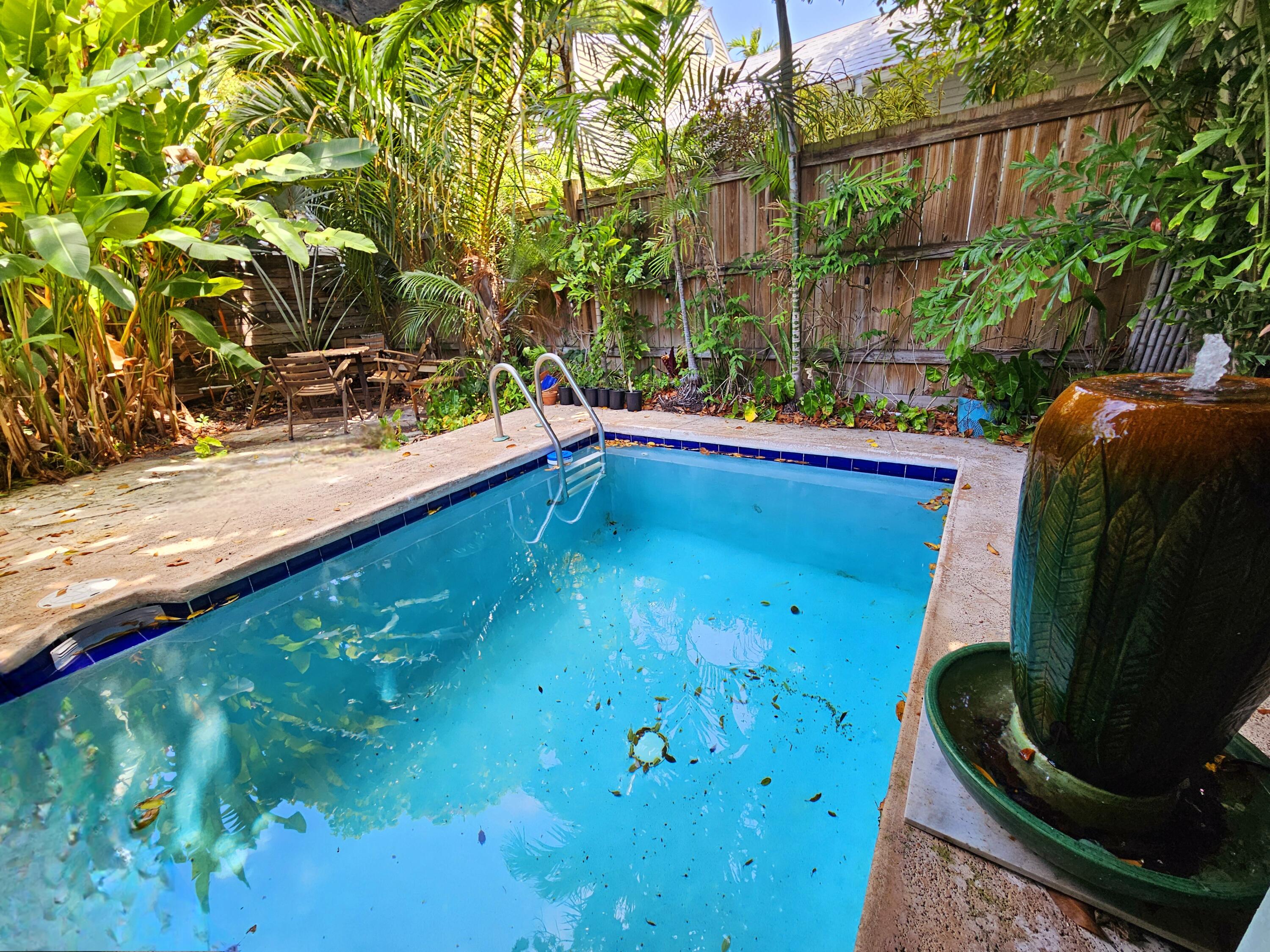 1015 Angela Street Key West, FL 33040 - Photo 19 of 42 a view of a swimming pool with a patio