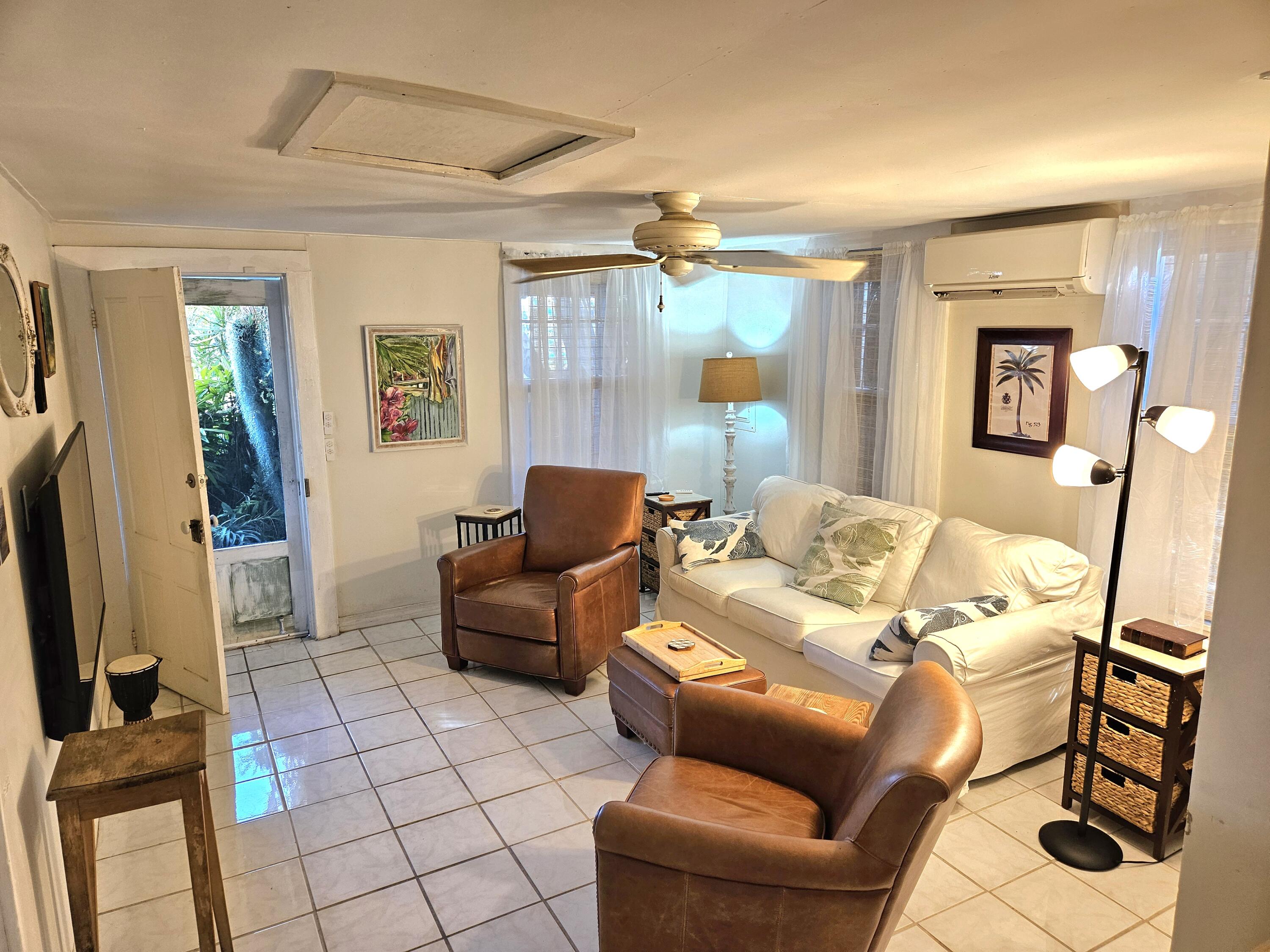 1015 Angela Street Key West, FL 33040 - Photo 22 of 42 a living room with furniture and a flat screen tv