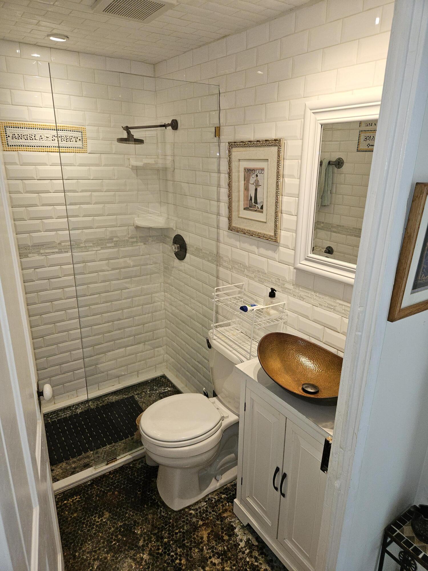 1015 Angela Street Key West, FL 33040 - Photo 31 of 42 a bathroom with a toilet a sink and shower