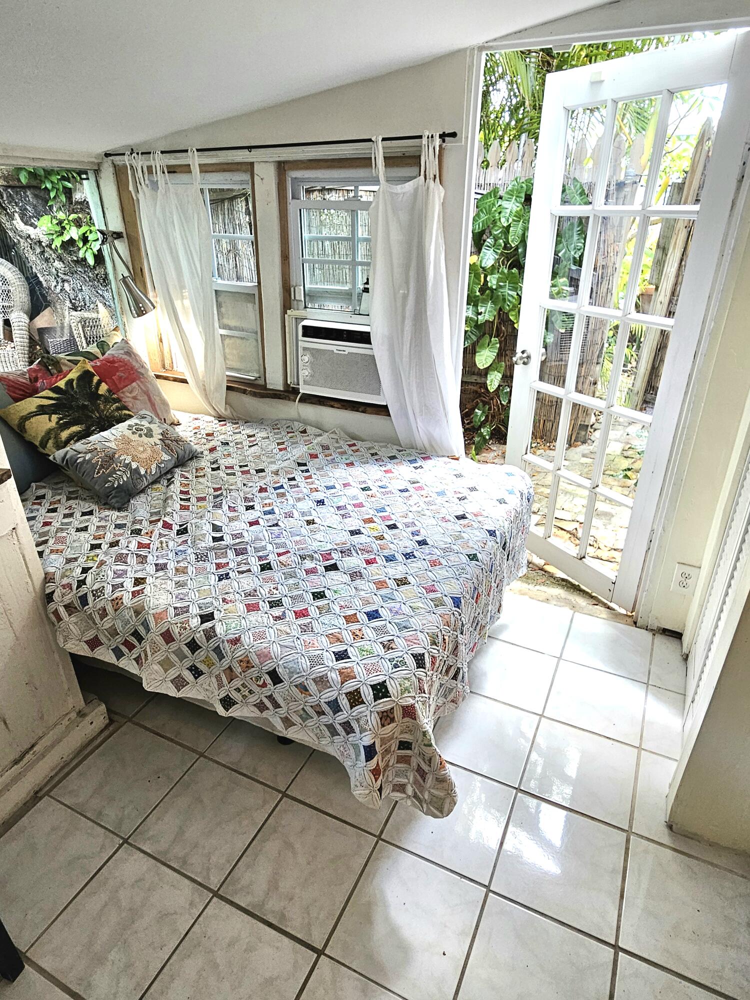 1015 Angela Street Key West, FL 33040 - Photo 35 of 42 a bed room with a bed and a window