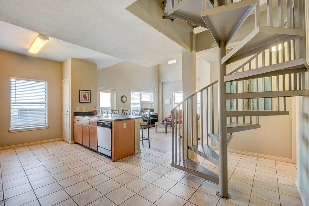 2515 Pearl Street, Unit 603 Austin, TX 78705 - Photo 6 of 15 a room with lots of wooden furniture and a chandelier