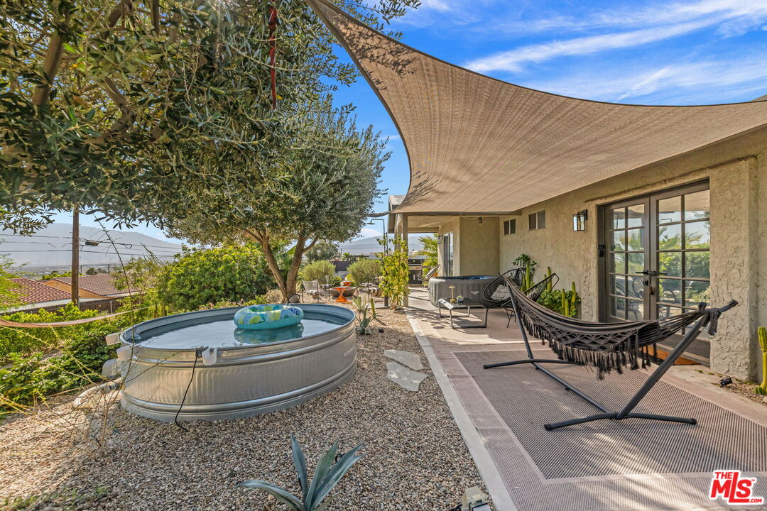 66869 San Ardo Road Desert Hot Springs, CA 92240 - Photo 32 of 39 a view of a swimming pool with a lounge chairs in patio