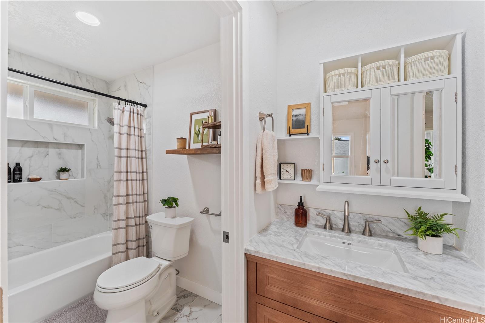 94-84 Keahilele Street Mililani, HI 96789 - Photo 15 of 20 a bathroom with a granite countertop sink a toilet a mirror and shower