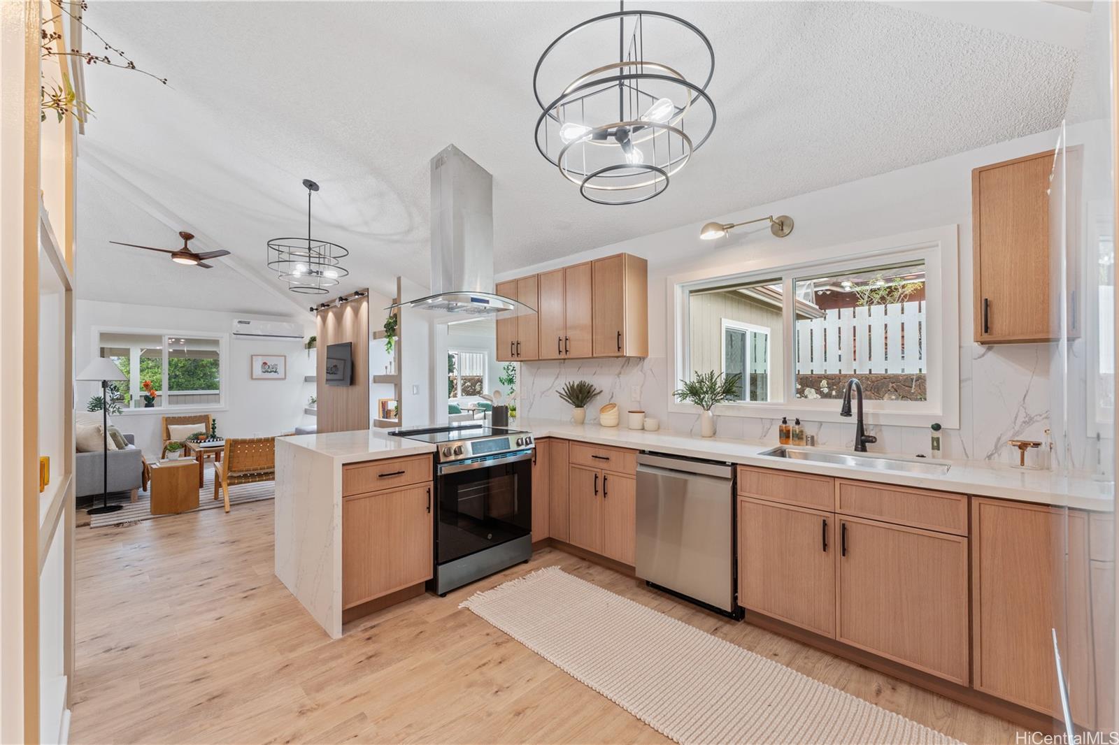 94-84 Keahilele Street Mililani, HI 96789 - Photo 8 of 20 a large kitchen with cabinets a sink and stainless steel appliances