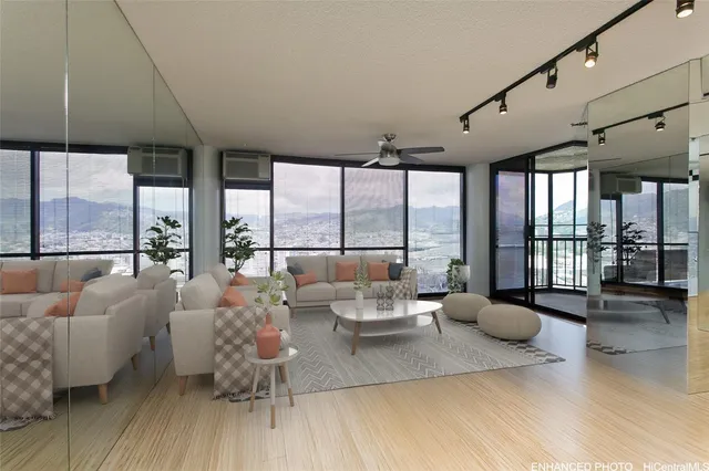 a living room with furniture and floor to ceiling windows