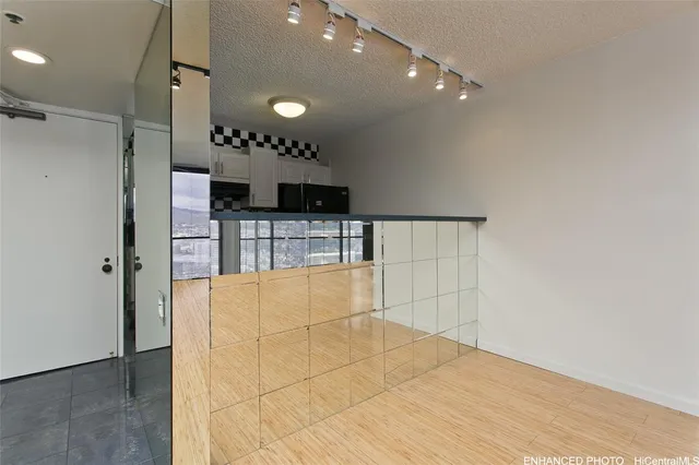 a view of kitchen with furniture and stainless steel appliances