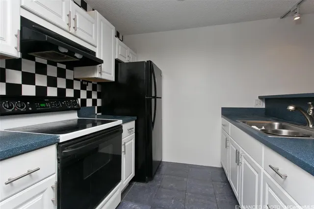 a kitchen with stainless steel appliances a stove and a refrigerator