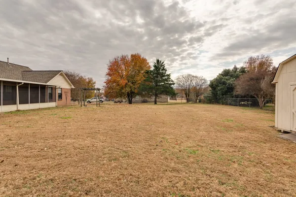 a backyard of a house with large trees