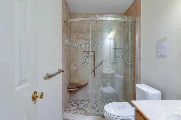 a bathroom with a sink toilet and shower