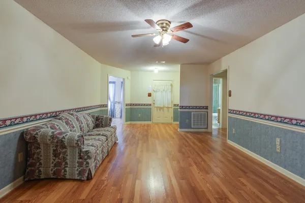 a view of wooden floor and chandelier in a room