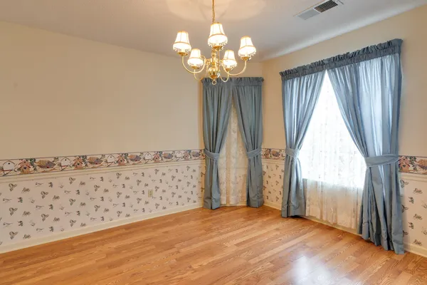 a kitchen with stainless steel appliances granite countertop a sink a stove and a wooden floors