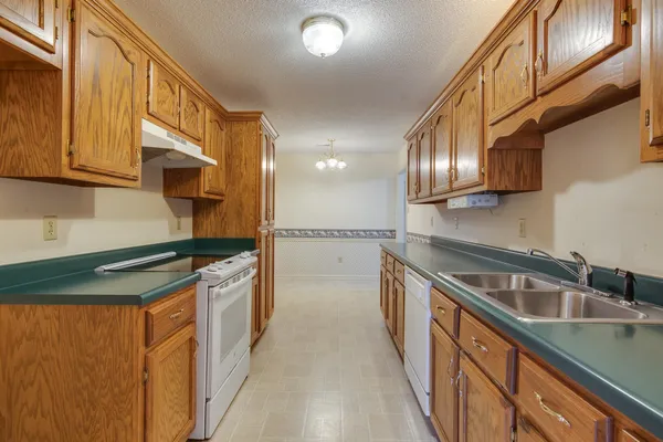 a kitchen with stainless steel appliances granite countertop a sink and cabinets