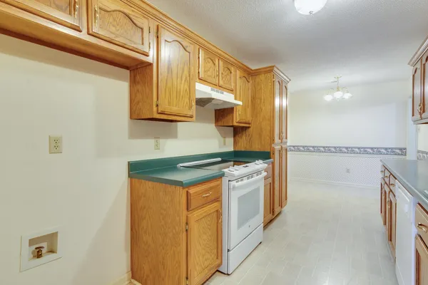 a kitchen with stainless steel appliances granite countertop a sink and stove top oven