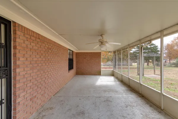 a view of a livingroom with a ceiling fan and window