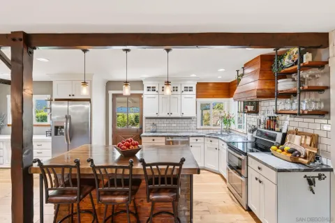 a kitchen with stainless steel appliances kitchen island granite countertop a sink and cabinets