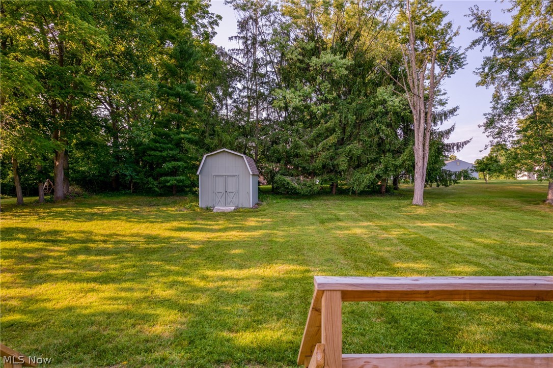 View of yard with a storage unit