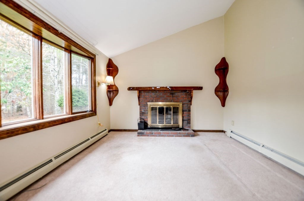 121 High Street Rochester, MA 02770 - Photo 16 of 33 a view of an empty room with fireplace and window