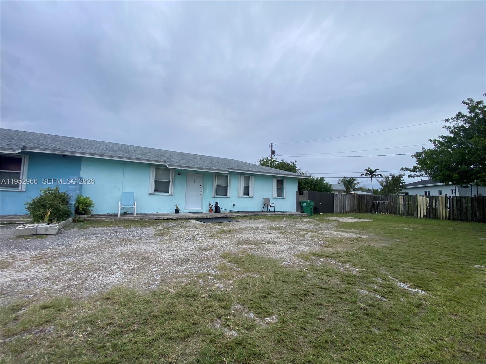 11545 Southwest 224th Street, Unit B Miami, FL 33170 - Photo 2 of 2 a view of a house with a backyard and garage